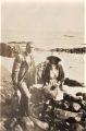 Harold Taylor with daughter Ngaire at seashore - note flagon Hal is holding